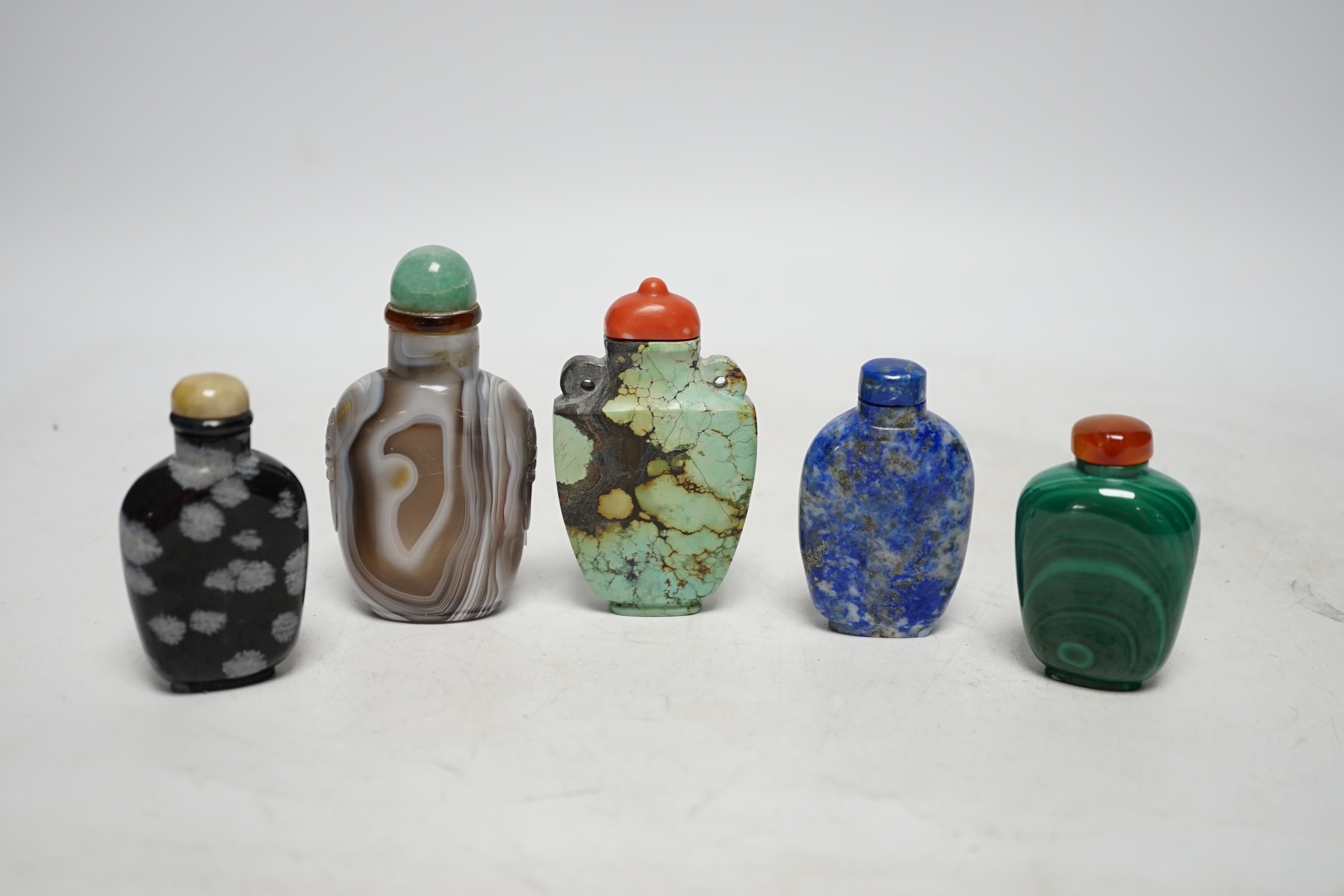 Five Chinese hardstone snuff bottles, 19th/20th century to include: black and grey marble, malachite, turquoise matrix, lapis lazuli and banded agate, largest 7.5cm high